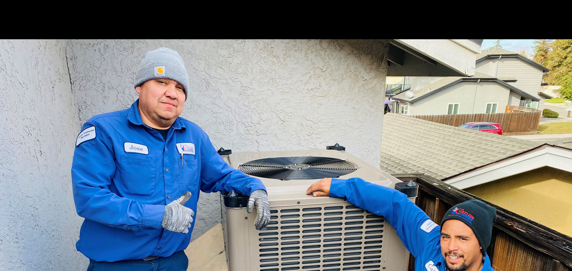 Costless Plumbing workers giving thumbs up next to AC unit